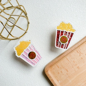 Close-up of popcorn-shaped phone grip with glitter sequins and colorful beads decoration