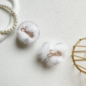 Close-up of plush heart and round phone sockets with sparkling rhinestone Smile text
