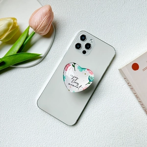 Floral heart phone socket with enjoy every moment text on white textured surface