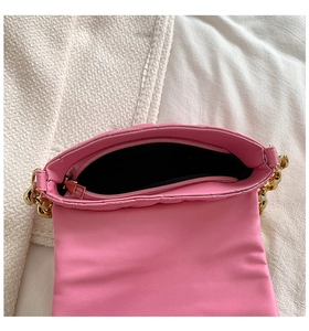 Detail view of pink quilted PU shoulder bag with internal compartment and gold chain strap