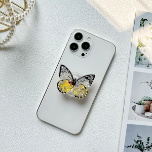 Sparkling yellow butterfly phone grip with glitter and sequins on a smartphone