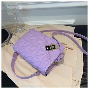 Close-up of a light purple quilted shoulder bag with a gold-tone square twist lock clasp