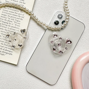 Sparkling heart rhinestone phone socket stand with pink crystals on white mobile phone