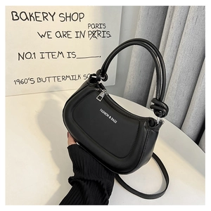 Close-up of a black retro semi-circular shoulder bag with white Fashion & Bags text logo