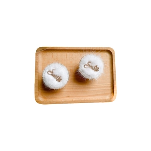 White plush phone socket grip with sparkling crystal Smile letter on wood tray