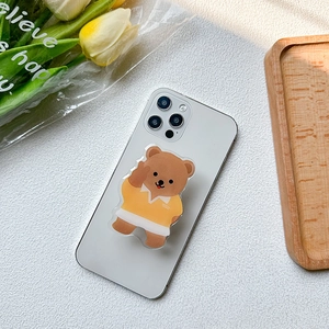Cute Korean Ins style brown bear phone grip stand on a white smartphone back
