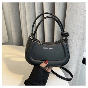 Detail of a black crescent shoulder bag with knot handle and Fashion & Bags text