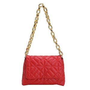 Detail of red quilted PU leather shoulder bag with bold gold acrylic chain strap