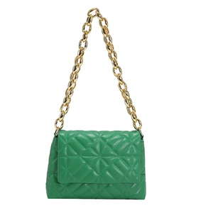 Detail of green quilted PU leather handbag with chunky gold acrylic chain strap