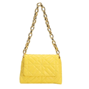 Close-up of bright yellow quilted shoulder bag with chunky gold metal chain strap detail