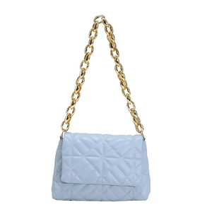 Detail of light blue quilted PU leather bag featuring a chunky gold acrylic chain strap