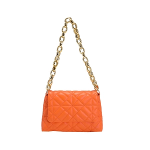 Detailed macro view of orange quilted PU handbag with chunky gold acrylic chain strap