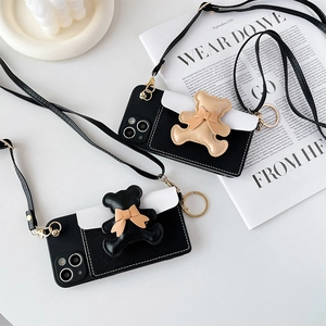 Crossbody iPhone case with a black bow bear wallet pouch and adjustable strap