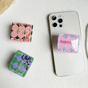 Three liquid quicksand pearl phone sockets with colorful beads and patterns on white surface