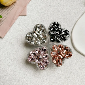Detailed view of luxury rhinestone heart-shaped collapsible phone stands in four colors