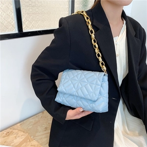 Quilted light blue PU leather shoulder bag with bold gold acrylic chain on model