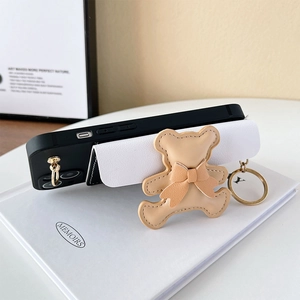 Detail of leather iPhone case with bear card holder wallet and crossbody strap attachment