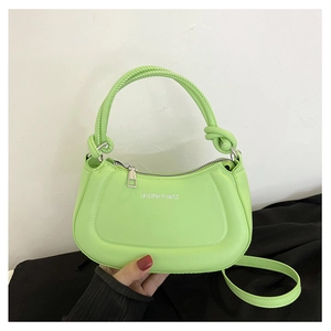 Detail of light green crescent handbag with knot handle and adjustable strap