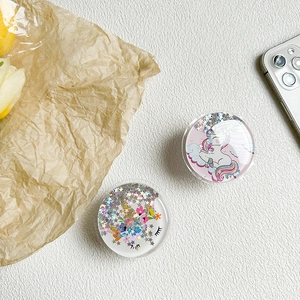 Detail of round unicorn phone grip with glitter sequins and cute rainbow patterns
