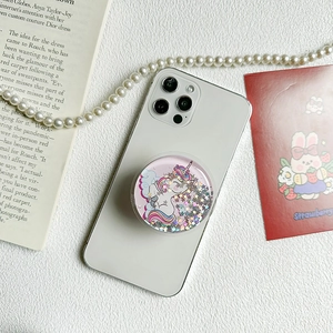 Glitter unicorn phone grip socket with star sequins on a white smartphone back
