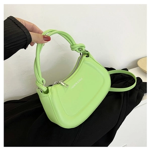 Macro detail of a light green crescent handbag with silver FASHION & BAGS lettering