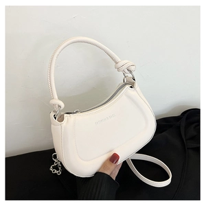 Detail of white crescent bag with knotted handle and Fashion & Bags embossed logo