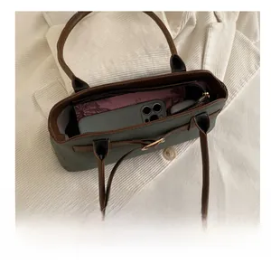 Interior view of large shoulder bag showing capacity for smartphone and wallet