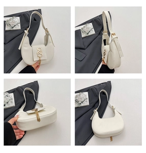 Four-angle detail of off-white crescent underarm bag with gold S-buckle and tassel
