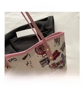 Detailed view of the pink handle and colorful city building print on a large tote bag