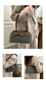 Detailed close-up of dark grey leopard suede bag with brown leather straps and metal buckle