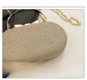 Close-up of golden glitter evening bag featuring a round handle and metallic texture