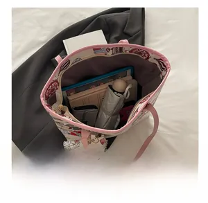 Top view of large tote bag interior showing capacity with books and tablet