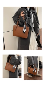 Detailed view of a brown pebbled tote bag featuring a decorative patterned silk scarf