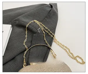 Detail of champagne gold sequin evening bag with metal ring handle and gold chain strap
