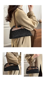 Detail of vintage dark leopard print underarm bag with leather strap and gold buckle