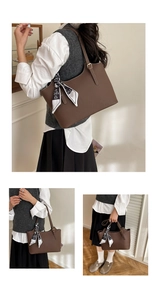 Detail of brown lychee leather tote with gold buckles and printed silk scarf handle