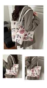 Detail of printed graffiti tote bag set featuring city landmarks and top handles