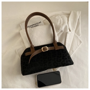 Detail of vintage leopard print suede shoulder bag with brown leather handle and gold buckle