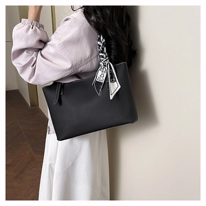 Litchi pattern black tote bag with black and white geometric silk scarf on handle