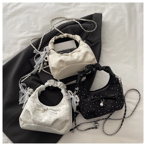 Chic pleated handbag with rhinestones and pearl bow, featuring a metal chain strap