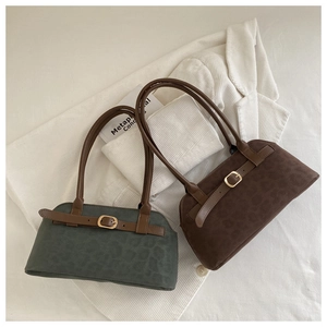 Detail of retro shoulder bags in dark green and brown with subtle leopard texture