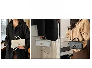 Detailed view of woven rectangular evening bags showing top handle and gold twist lock strap