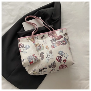 Flat lay of pink trimmed cartoon tote bag with matching coin purse and travel patterns