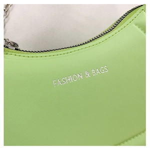 Detail of neon green PU leather bag with silver zipper and Fashion & Bags silver logo