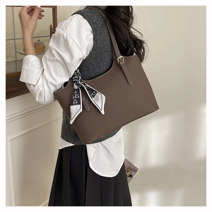 Brown leather tote bag styled with geometric scarf and business casual outfit