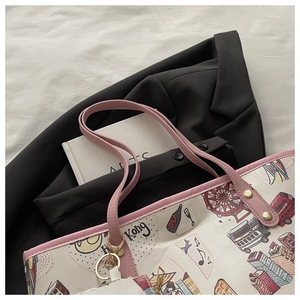Detail of canvas tote bag with pink handles and city-themed illustration print