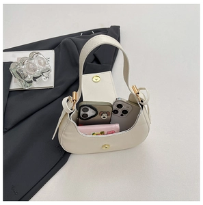 Interior view of white crescent hobo bag showing space for phones and a wallet