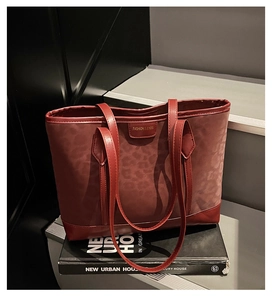 Detail of burgundy leopard print tote bag with Fashion & Bags metal logo plaque
