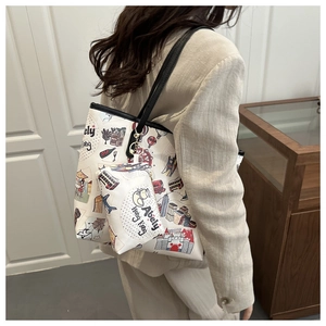 Detail view of stylish tote bag and small pouch featuring unique Hong Kong city illustrations