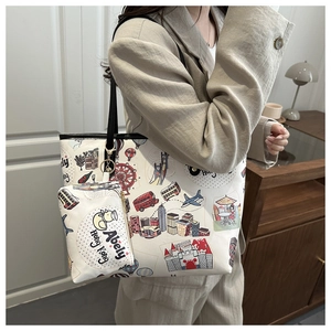 Detail of white city-themed tote with colorful graffiti prints and black handles